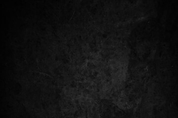 Fototapeta premium Dark, textured background with a rough, stone-like appearance in shades of black and gray