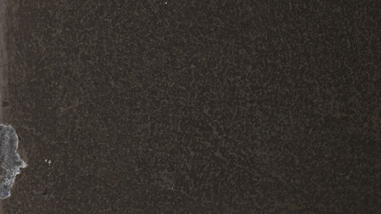 Fototapeta premium Dark, textured desktop wallpaper with a rough, cracked surface and a subtle grayish tone