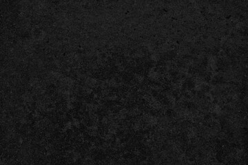 Fototapeta premium Dark textured background with a rough, grainy surface in deep black tones