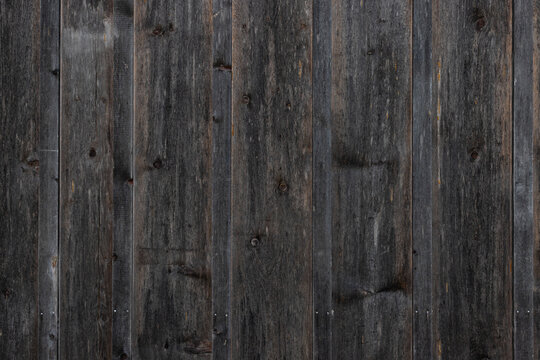 Dark rustic vertical wooden boards texture with moody weathered surface