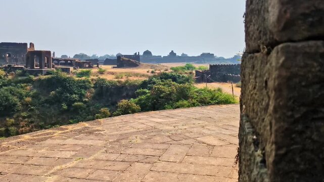 Reveal shot of ( Diwan-i-Aam ) The principle hall in bidar fort, trees and sky at karnataka, india. day time, slight pan shot, hand held shot, 4k.