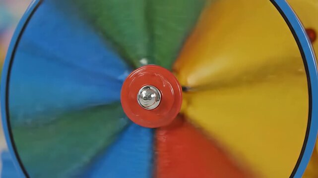 Colorful Spinning Wheel Toy in Motion, Bright Primary Colors