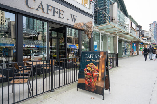 Vancouver, BC, Canada - Mar 23, 2026: Advertising for Dubai chocolate strawberry cups, using an AI-generated image, is seen outside a cafe on Robson Street in Vancouver. Unreal images vs real life.