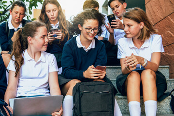 Fototapeta premium Students using technology outdoors photo