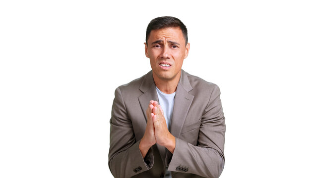 Man with concerned expression making praying gestures