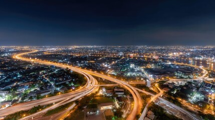 Fototapeta premium Stunning Night View of a Vibrant Cityscape with Illuminated Roads and Urban Landscape at Dusk