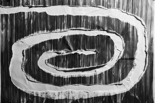 Abstract Black and White Torn Paper Spiral Collage with Gritty Texture
