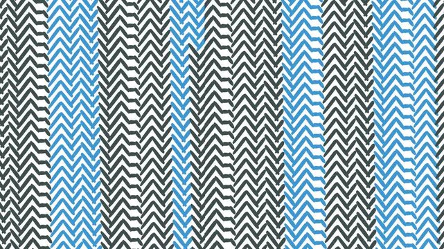 The movement of the ribbed texture with stripes where there are small angular shapes.