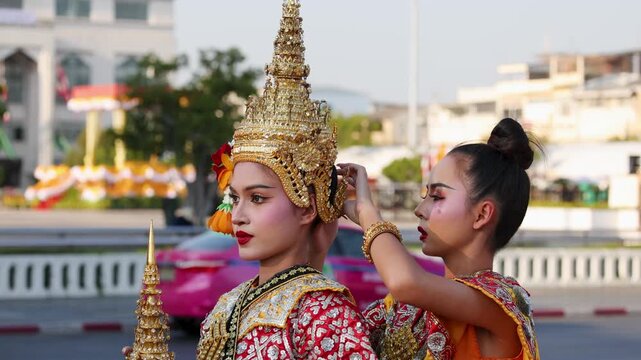 Thai Khon Dancer Receiving Final Costume Adjustments in Outdoor Bangkok Setting