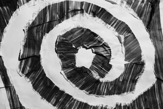 Macro View of Black and White Torn Paper Spiral with Gritty Texture