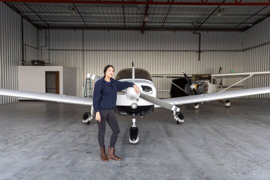 Pilot standing by small aircraft