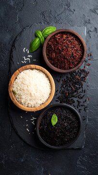 Assortment of cooked rices in wooden bowls, with basil leaves