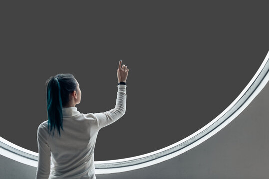 Woman pointing futuristic circular window, suitable as mockup