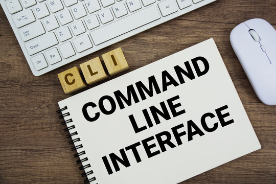CLI Command-Line Interface message with keyboard and optical mouse on wooden background