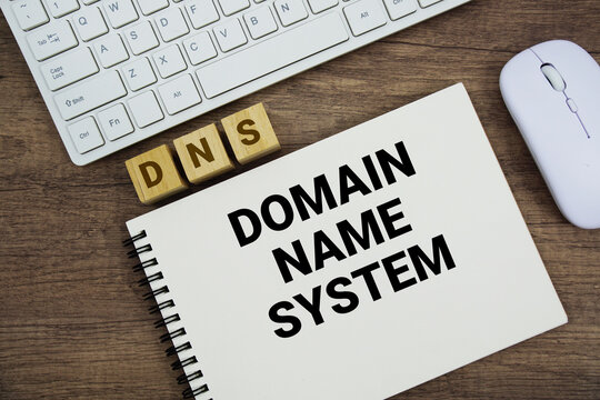 DNS Domain Name System message with keyboard and optical mouse on wooden background