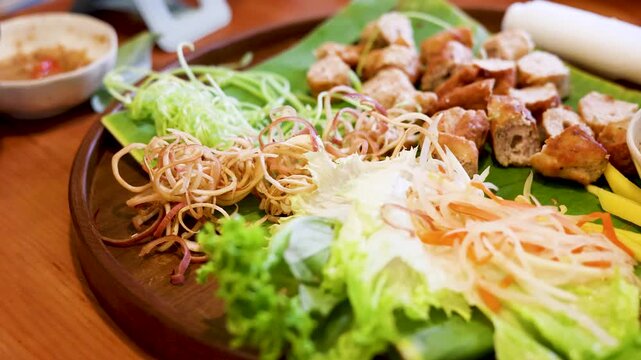 Vietnamese Nem Nuong Grilled Pork Sausage Platter with Fresh Herbs