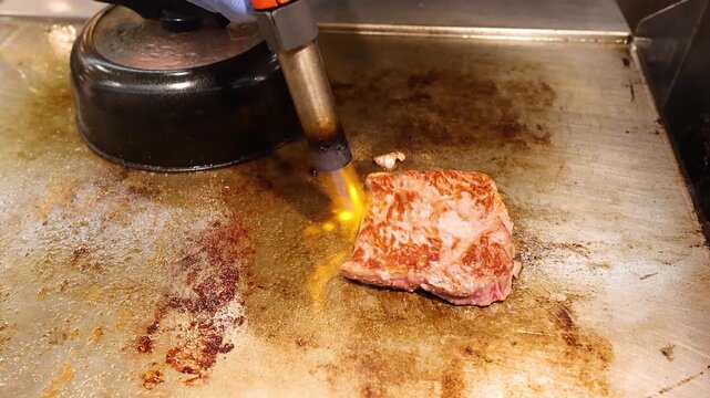 Japanese Chef Searing Wagyu Beef with Blowtorch at Kuromon Market