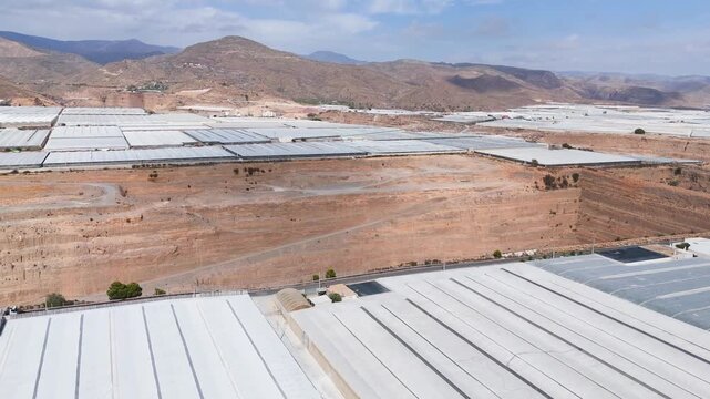 mine industry business field agriculture dig mining capitalism greenhouse industrial invernaderos roof plastic sea architecture excavation mountain earth terra forming - Andalusia, Spain - 2025