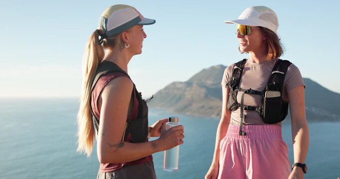 Outdoor, friends and women with smart watch for hiking, check step counter and journey time discussion. Ocean, trekking adventure and people with tech for distance tracking, talk and smile on holiday