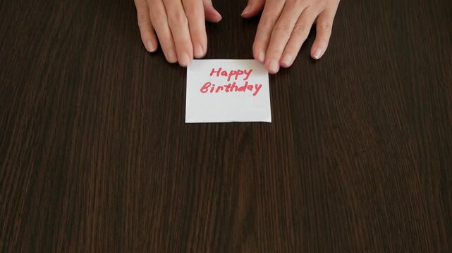 Zefir or marshmallows as pink rose, red car model and happy birthday card in hand, Concept