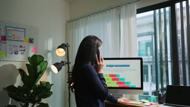 Young woman enjoys a quick break from remote work, scrolling on her smartphone to relax, embracing digital wellness, work-life balance, and mindful screen use in a flexible home office setup