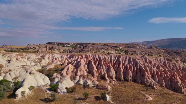 Aerial view of fairy chimneys in Cappadocia, Turkey under clear blue sky