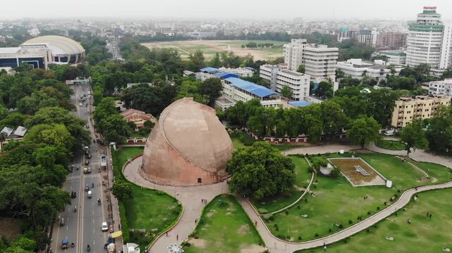 Aerial drone view of Golghar in Patna, Bihar, showcasing the iconic historic granary surrounded by urban landscape, greenery, and the scenic skyline of the city.
