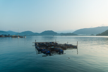 Authentic Overwater Wooden House and Floating Fishing Raft in Tropical Bay © artrachen