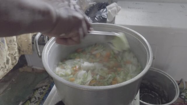 Stirring Vegetable Soup with Potato Carrot and Cabbage in Boiling Pot