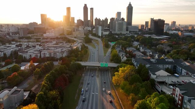Cinematic aerial daytime footage of a massive, multi-level highway interchange and busy traffic near Georgia State in downtown Atlanta.