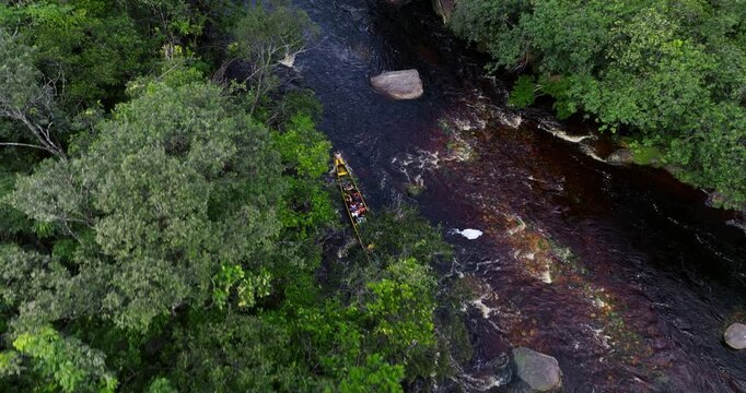 Tourists On Long Motorboat Navigating Rocky Waters Of Churun River In Canaima National Park, Venezuela. aerial tracking shot