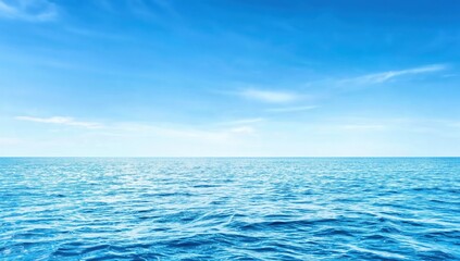 Fototapeta premium Vast ocean with gentle waves under a clear blue sky, evoking calmness and endless horizon.