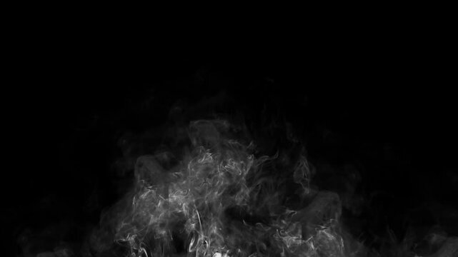 Smoke rose from below and then dissipated. The rising smoke was isolated against the black background.