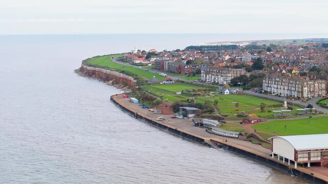 Aerial video of the British seaside town of Hunstanton in Norfolk showing the coastal area and beach and alsop the caravan holiday park. Chalk white cliffs with a lighthouse and sandy beach