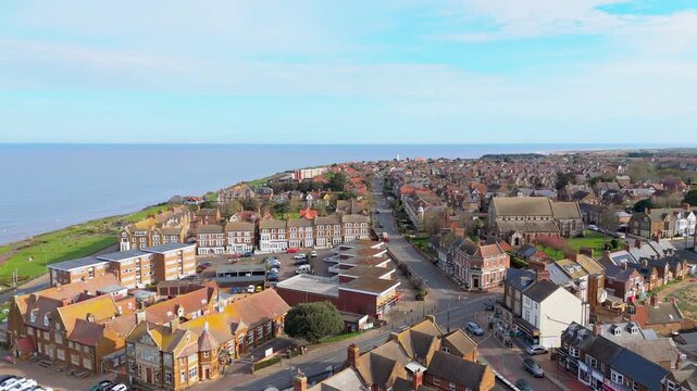 Aerial video of the British seaside town of Hunstanton in Norfolk showing the coastal area and beach and alsop the caravan holiday park. Chalk white cliffs with a lighthouse and sandy beach
