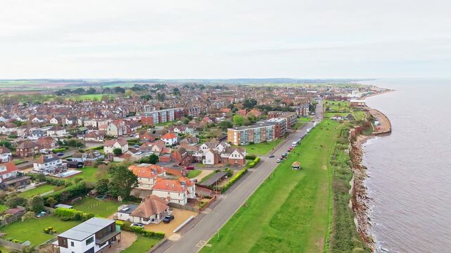Aerial video of the British seaside town of Hunstanton in Norfolk showing the coastal area and beach and alsop the caravan holiday park. Chalk white cliffs with a lighthouse and sandy beach
