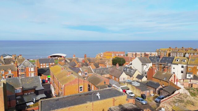 Aerial video of the British seaside town of Hunstanton in Norfolk showing the coastal area and beach and alsop the caravan holiday park. Chalk white cliffs with a lighthouse and sandy beach