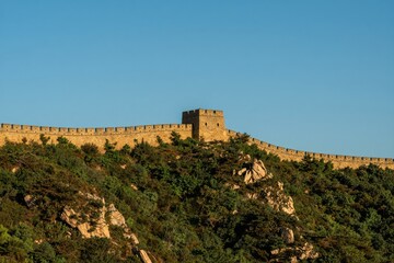 Fototapeta premium Ancient Stone Fortress Perched Atop Forested Mountain Ridge