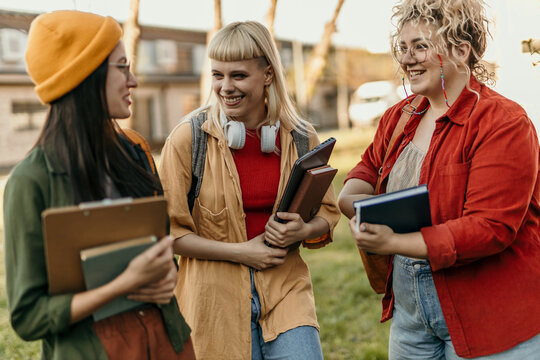 Diverse students walking on campus discussing university life