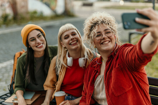 Group of diverse gen z women taking selfie