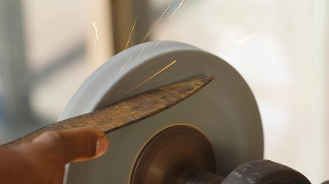 Street craftsman sharpening large scissors shear manually