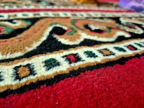Close-up of Traditional Ornamental Carpet Texture with Intricate Patterns