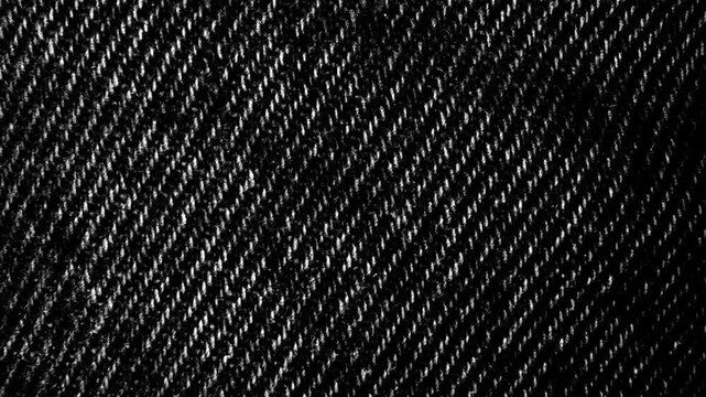 Black Denim Fabric Texture Background. Close-up video of rugged black denim twill for design backgrounds.