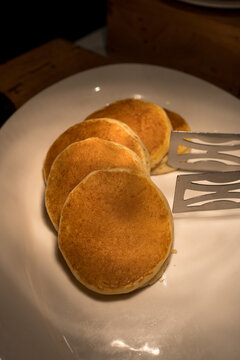 Stack of fluffy pancakes on dish in buffet