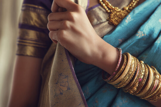 Detailed view of hindu woman adjusting sari pallu with bangles and traditional jewelry visible, soft natural lighting in clean