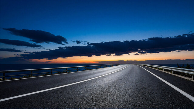 Open road at sunset with dramatic clouds over the ocean