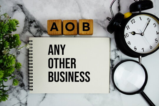 AOB Any Other Business text with alarm clock and magnifying glass on marble background