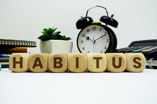 HABITUS alphabet letters with alarm clock and calculator on white background