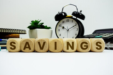SAVINGS alphabet letters with alarm clock and calculator on white background © may1985