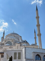 Obraz premium Majestic Mosque with Tall Minarets and Large Domes under Blue Sky